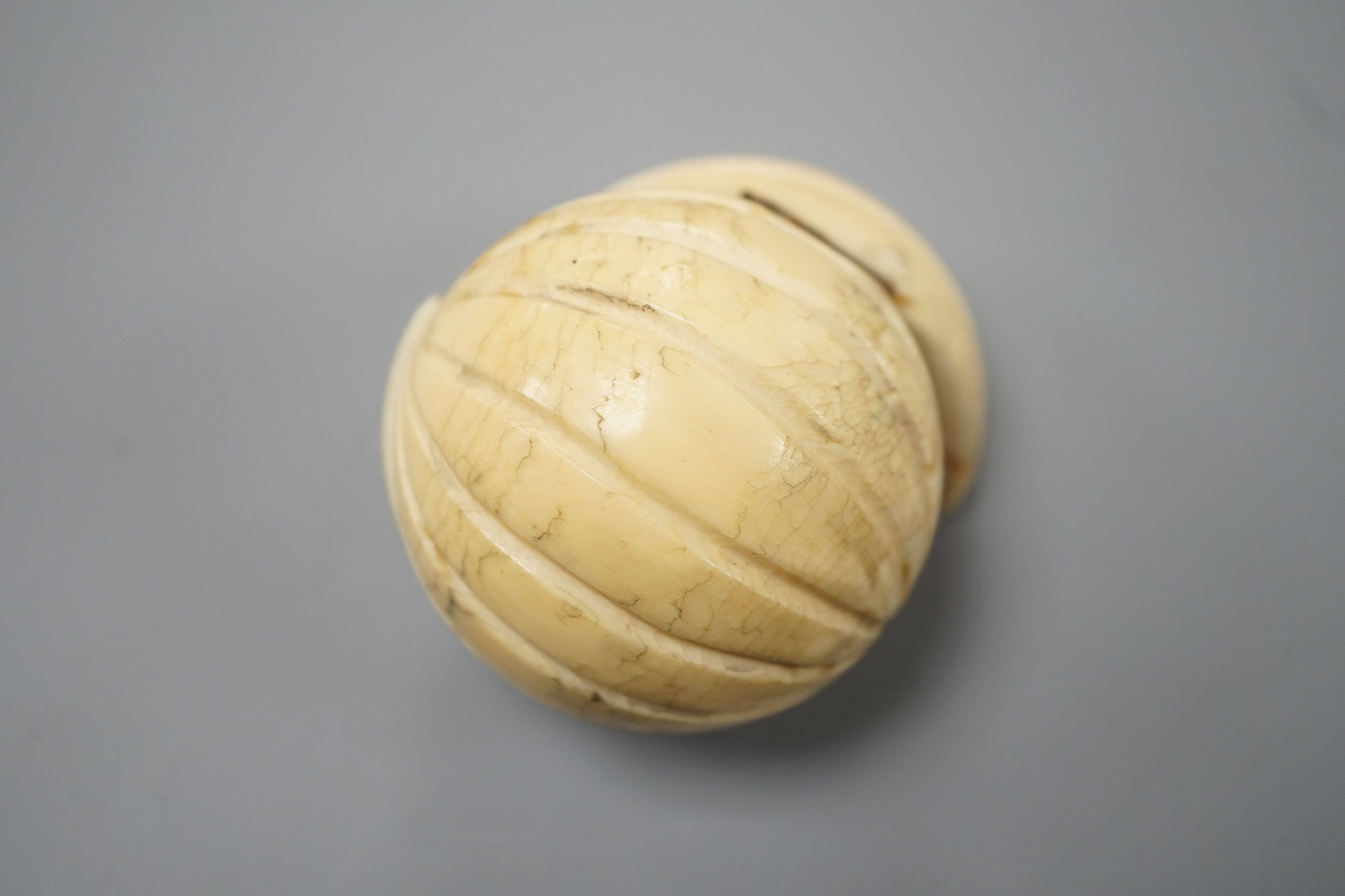 A 19th century Dieppe ivory globular triptych, possibly depicting Crimean war figures, 5.4cm diameter closed
